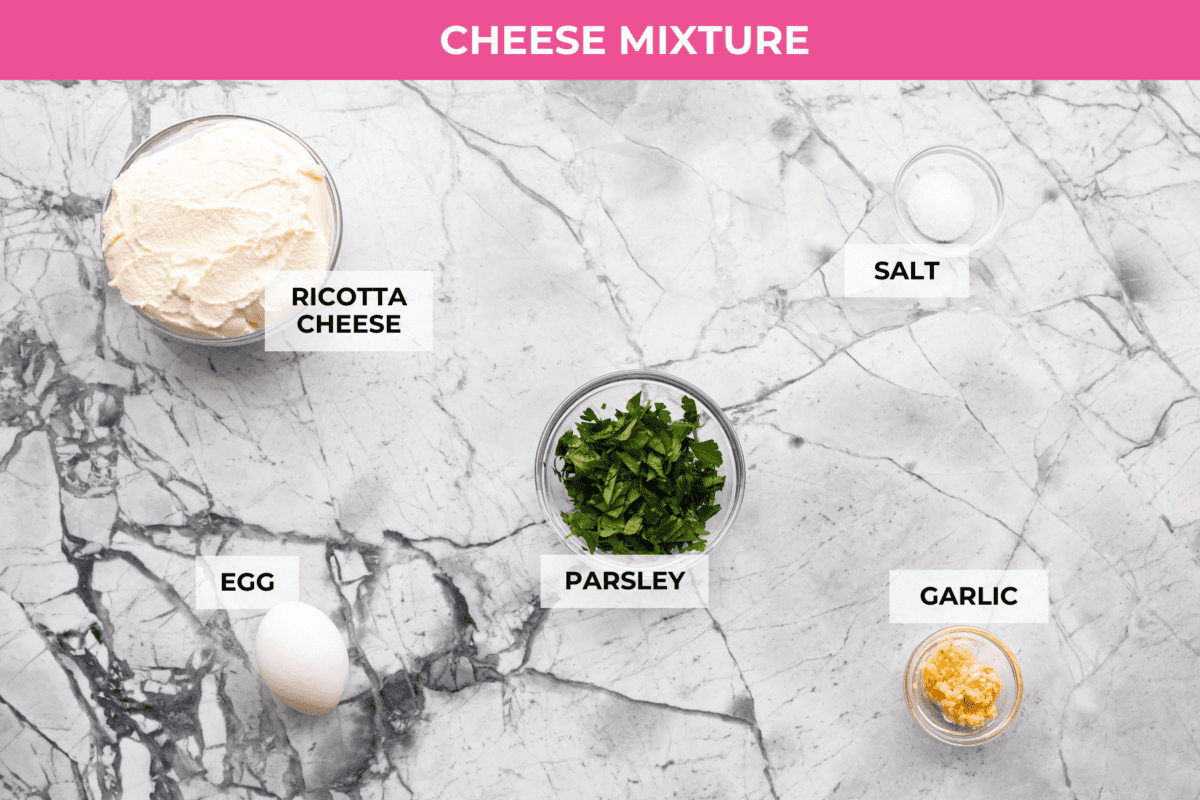 If youโre a seafood lover, you'll be obsessed with this Seafood Lasagna. Iโm talking crab, scallops, and shrimp in creamy, cheesy layers, baked to bubbly perfection. Itโs my go-to dinner when Iโm cooking for seafood fans! Overhead shot of labeled cheese mixture ingredients.
