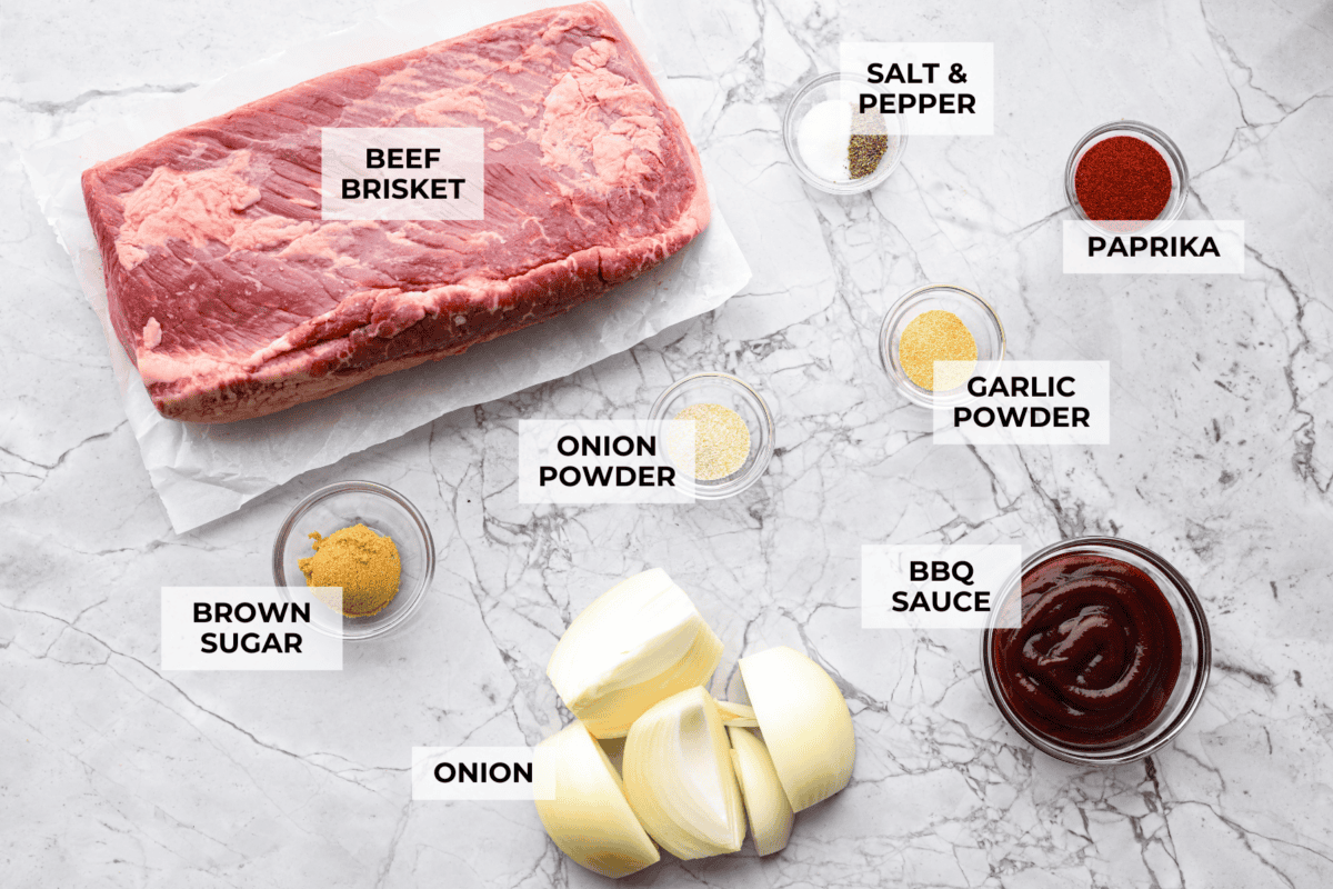 This Slow Cooker Beef Brisket is melt-in-your-mouth tender, packed with flavor, and practically cooks itself. Perfect for easy family dinners or feeding a hungry crowd! Overhead shot of labeled ingredients.
