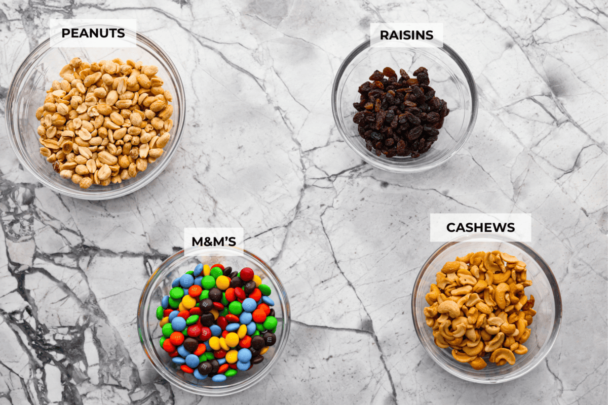 Trail mix is my go-to snack for busy days, road trips, or tossing in the kids' lunchboxes. Packed with flavor and endless mix-ins, trail mix is the perfect snack for any time! Overhead shot of labeled ingredients