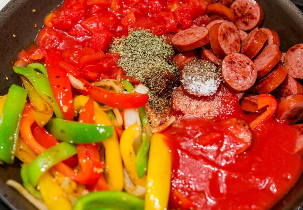 Apparently garlic fixes everything, and you knew it before I did. After a few of you suggested adding it to this Italian Sausage & Peppers, I gave it a tryโฆ and wow! Turns out, garlic takes this from good to seriously addictive. Seasonings, diced tomatoes and tomato sauce added to the vegetables in the skillet along with the sausage.
