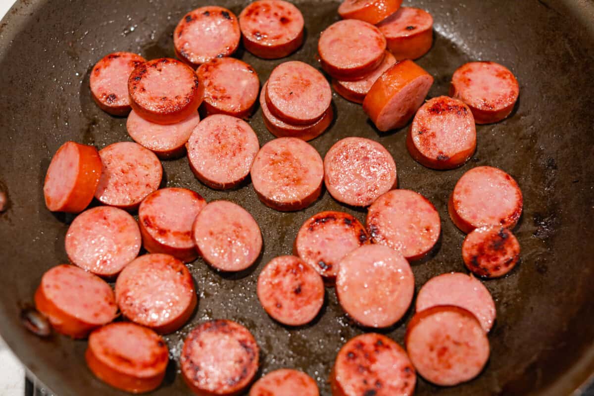 Apparently garlic fixes everything, and you knew it before I did. After a few of you suggested adding it to this Italian Sausage & Peppers, I gave it a tryโฆ and wow! Turns out, garlic takes this from good to seriously addictive. Italian sausage cooking in a skillet.