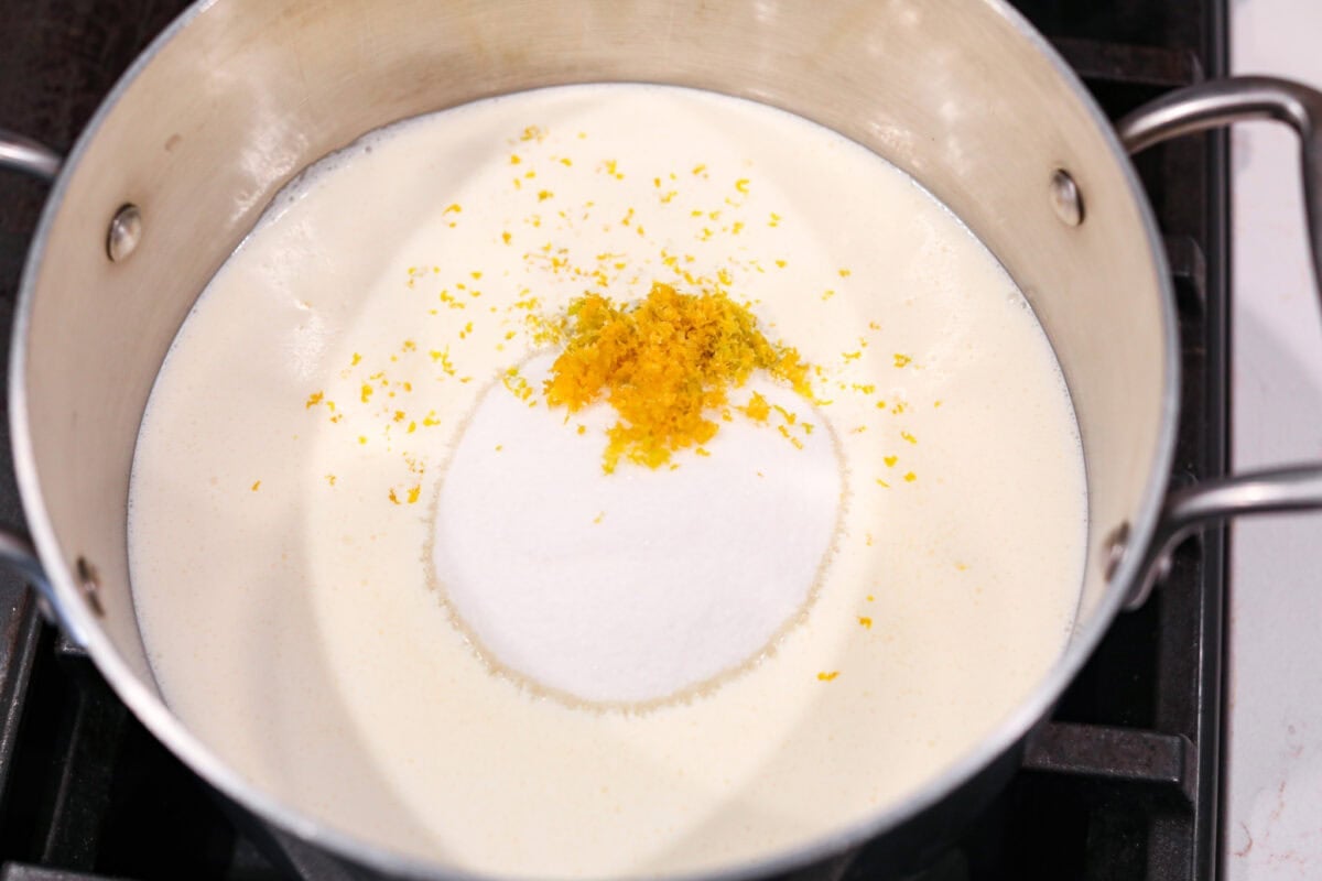 Lemon Posset- Only 5 Ingredients! Cream, sugar and lemon in a pot on the stove.