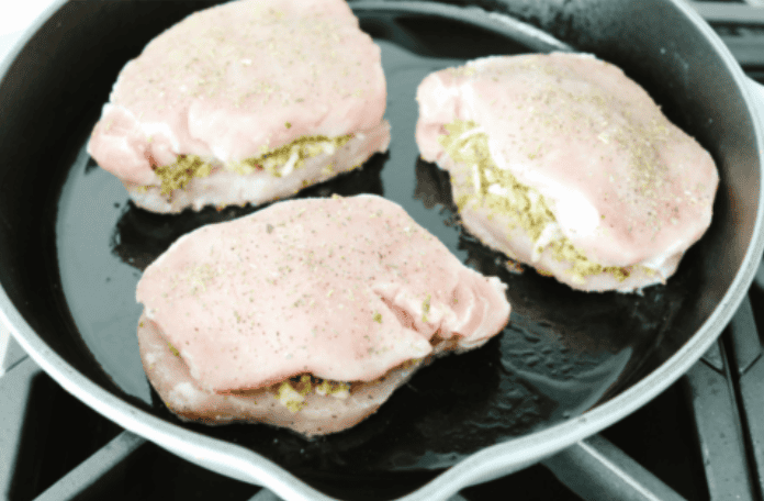 Stuffed pork chops sound fancy, but they’re super easy and budget-friendly. I’ll show you how to keep the pork chops moist and stuffed with gooey, cheesy deliciousness! Stuffed pork chops searing in a griddle.