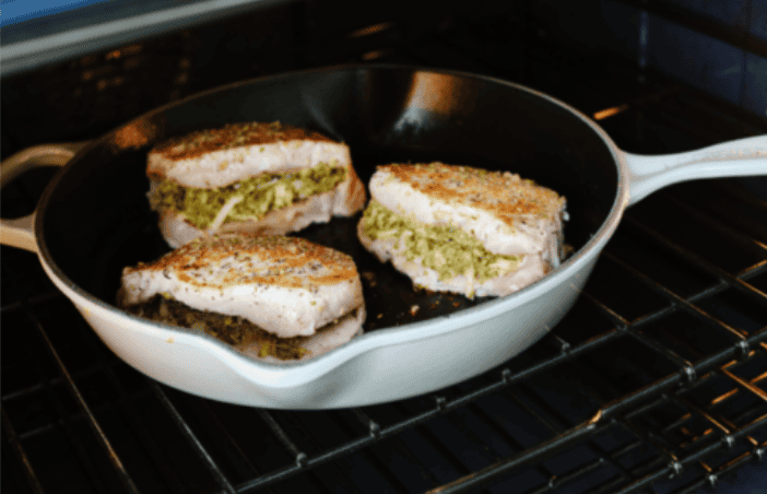 Stuffed pork chops sound fancy, but they’re super easy and budget-friendly. I’ll show you how to keep the pork chops moist and stuffed with gooey, cheesy deliciousness! Seared pork chops in the skillet in an oven.