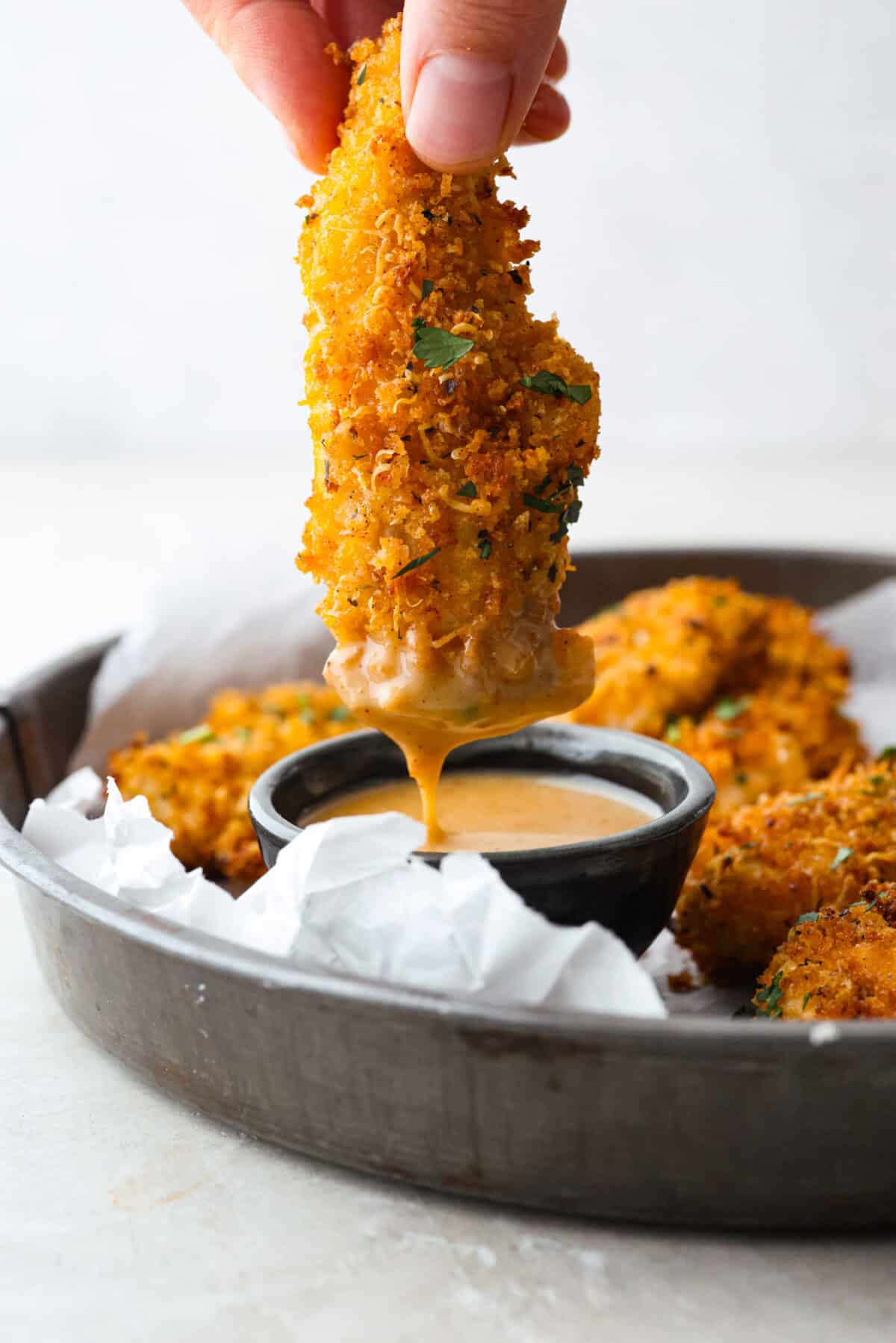 These air fryer chicken tenders are a lifesaver on crazy weeknights. Crispy, cheesy, and full of flavorโplus they cook up fast and my kidsย actuallyย ask for seconds. Total win! Someone pulling up from dipping it in sauce.
