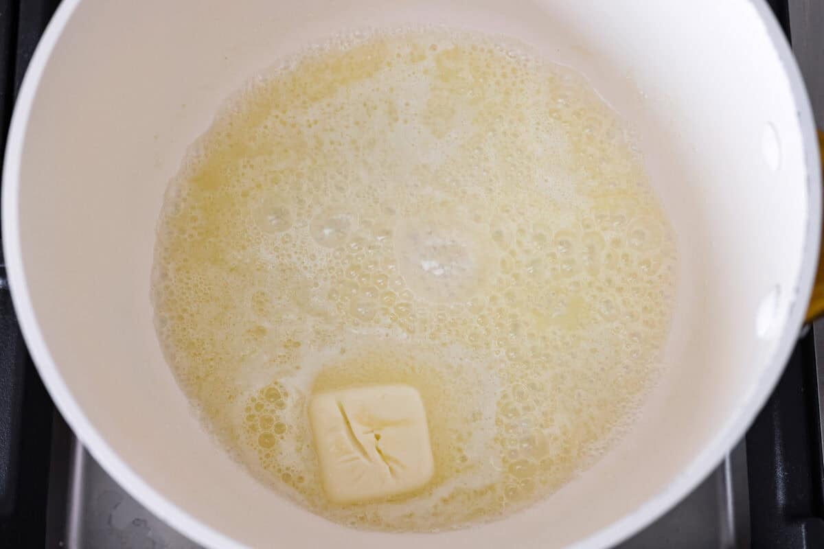 My homemade cheese sauce is ultra-creamy, wildly easy, and totally better than anything from a jar. Mild for kids, bold enough for nachosโamazing on everything! Melted butter in a pot on the stove.