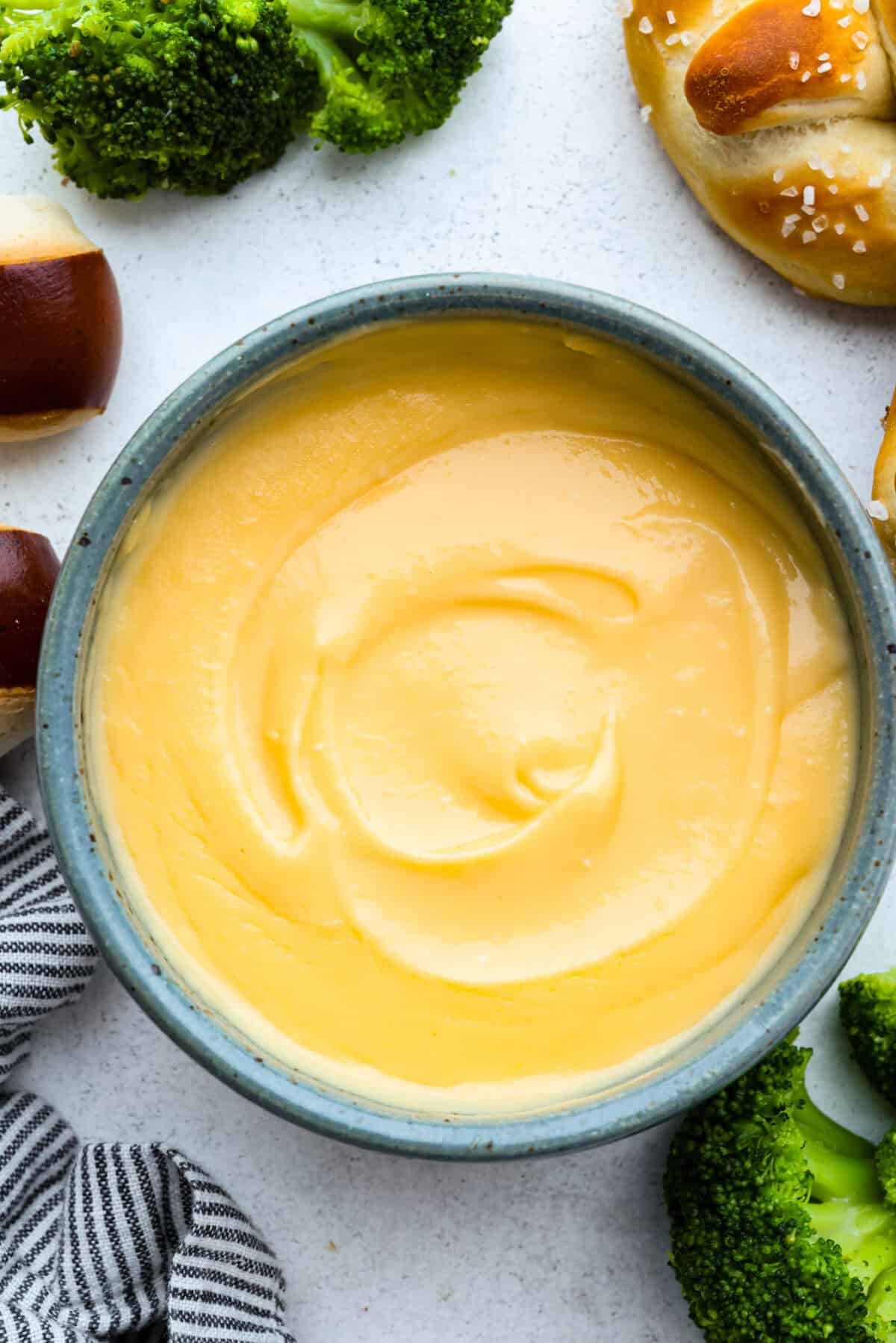 Melt: In aย medium-sized saucepan, and the unsalted butter. Heat over medium heat until the butter melts. Whisk: Whisk in the all-purpose flour until it makes a roux. Stir: Add in the milk and shredded cheddar cheese to the flour mixture and stir to combine. Melt: Whisk until the cheese is melted and smooth. Overhead shot of homemade cheese sauce.