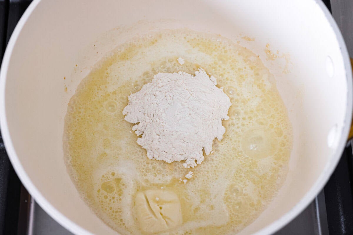 My homemade cheese sauce is ultra-creamy, wildly easy, and totally better than anything from a jar. Mild for kids, bold enough for nachosโamazing on everything! Flour added to the melted butter in a pot.
