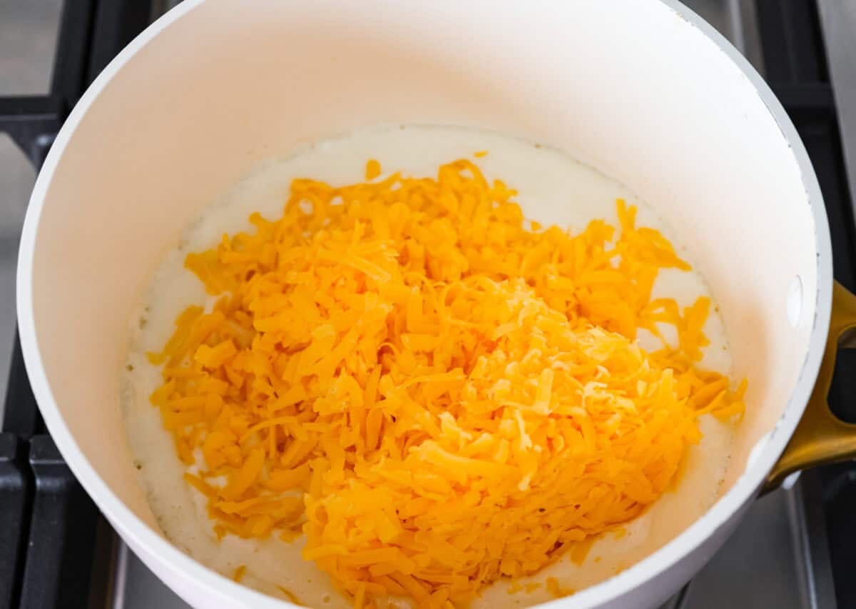 Melt: In aย medium-sized saucepan, and the unsalted butter. Heat over medium heat until the butter melts. Whisk: Whisk in the all-purpose flour until it makes a roux. Stir: Add in the milk and shredded cheddar cheese to the flour mixture and stir to combine. Melt: Whisk until the cheese is melted and smooth. Milker and cheese added to the roux.