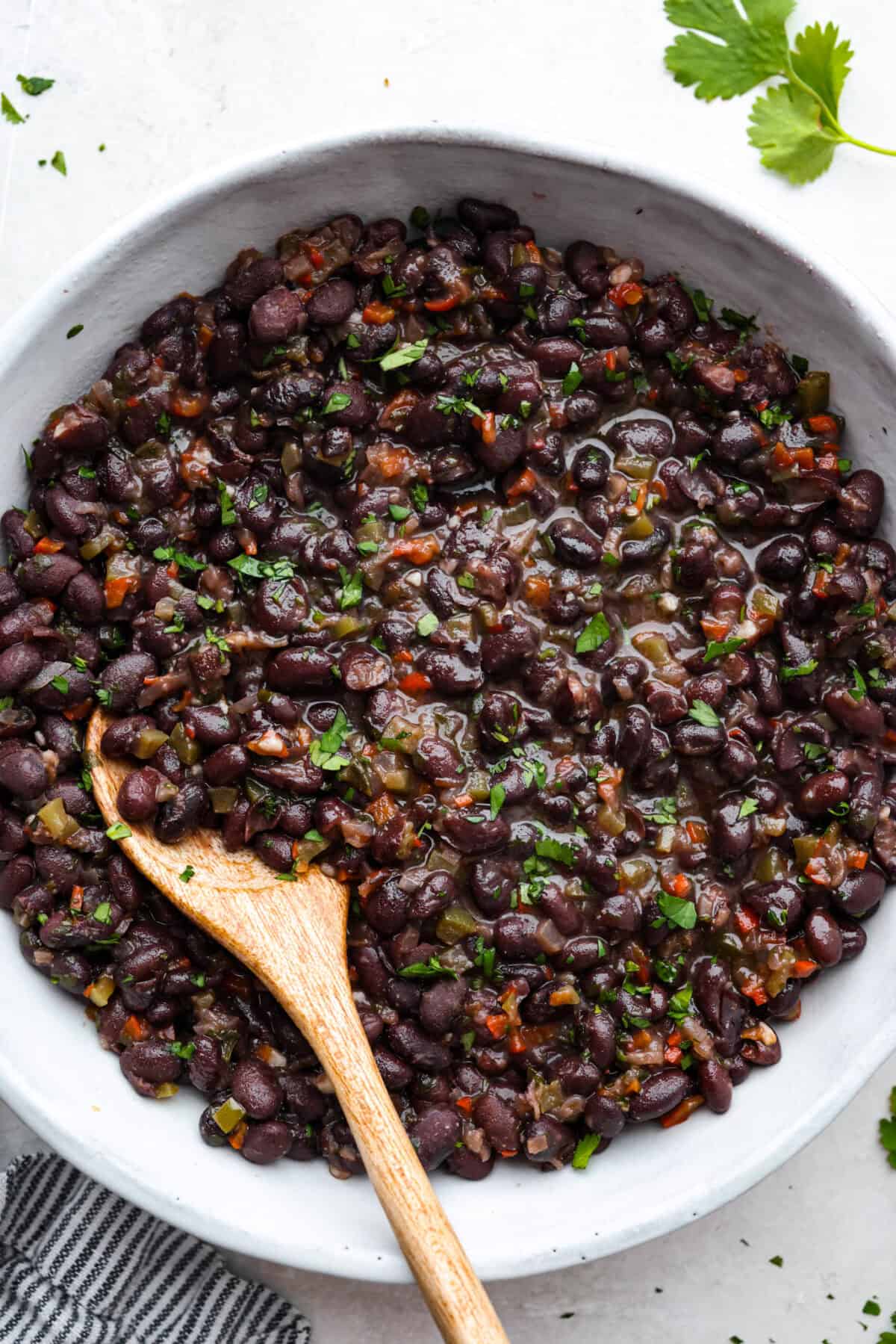 For these Cuban Black Beans, I used canned black beans to save time on soaking and cooking, so you can enjoy that rich, homemade flavor in a fraction of the time! Overhead shot of Cuban black beans in a serving dish.