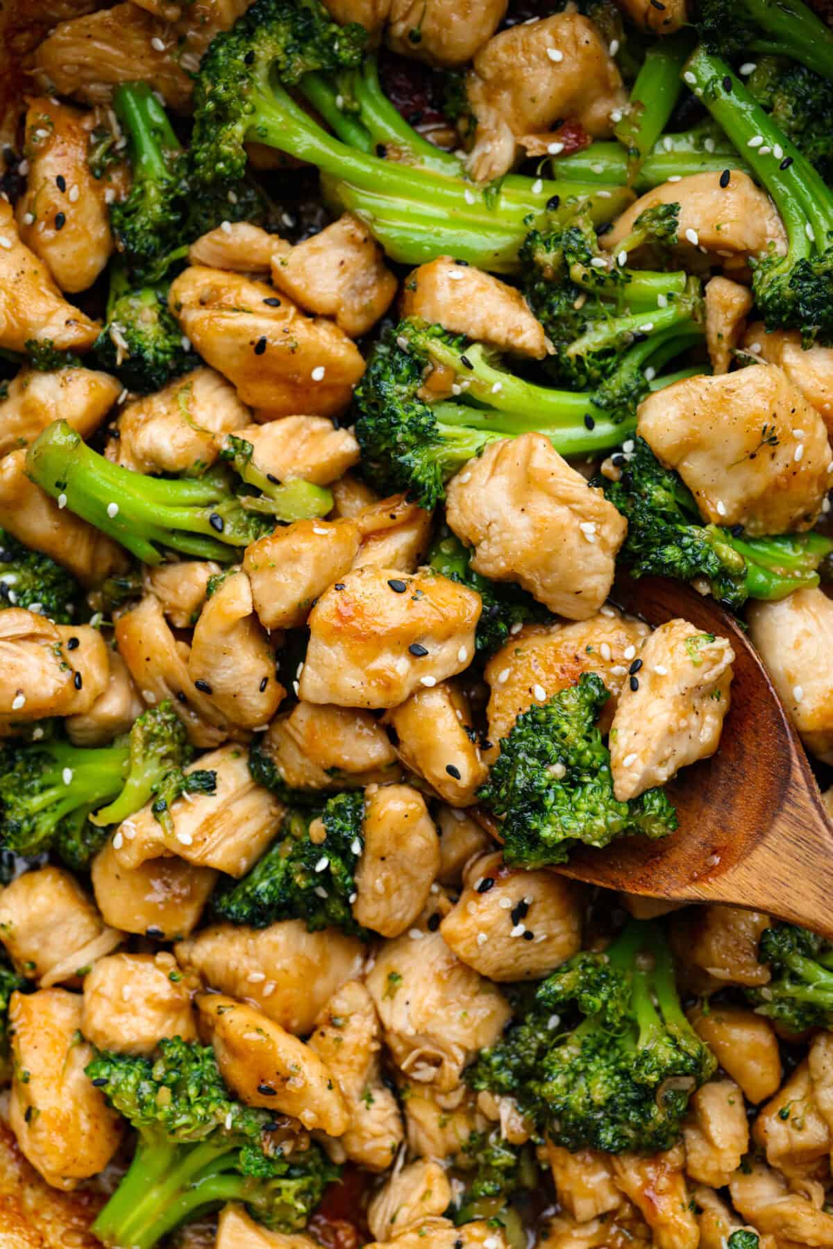 Skillet Sesame Chicken & Broccoli is your new favorite weeknight winner! With sweet and savory flavors in every bite, this easy stir-fry comes together in just 30 minutes. Close up of sesame chicken and broccoli.