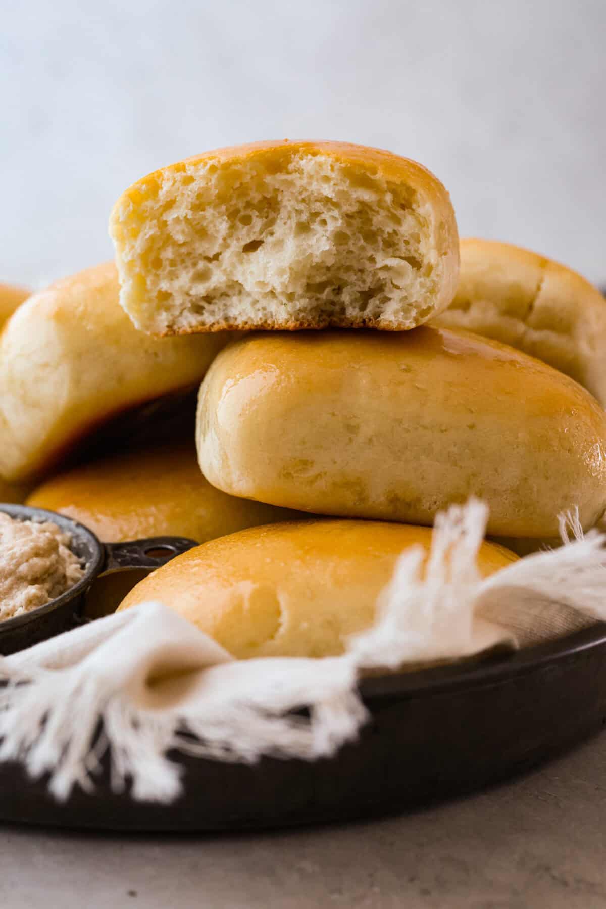 I am obsessed with Texas Roadhouse rollsโlike, zero self-control as soon as they hit the table. So, of course, I had to recreate them at home! These copycat Texas Roadhouse rolls are soft, fluffy, slightly sweet, and melt-in-your-mouth good. Stack of Texas Roadhouse rolls.