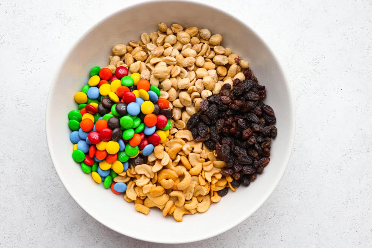 Trail mix is my go-to snack for busy days, road trips, or tossing in the kids' lunchboxes. Packed with flavor and endless mix-ins, trail mix is the perfect snack for any time! All of the ingredients added to a bowl.