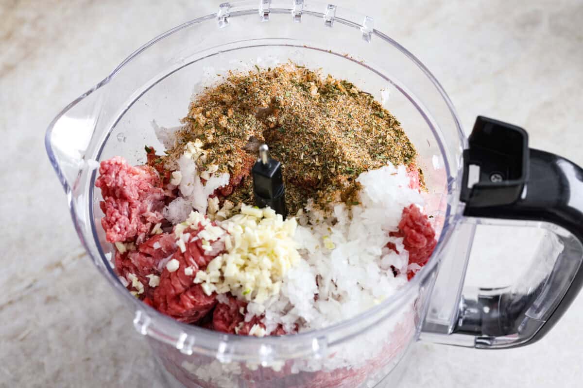 My easy-to-make gyro meat is perfectly seasoned and tender every time! Just like your favorite Mediterranean restaurant. Perfect for pitas, bowls, or platters with all your favorite toppings. All gyro meat ingredients added to a food processor.