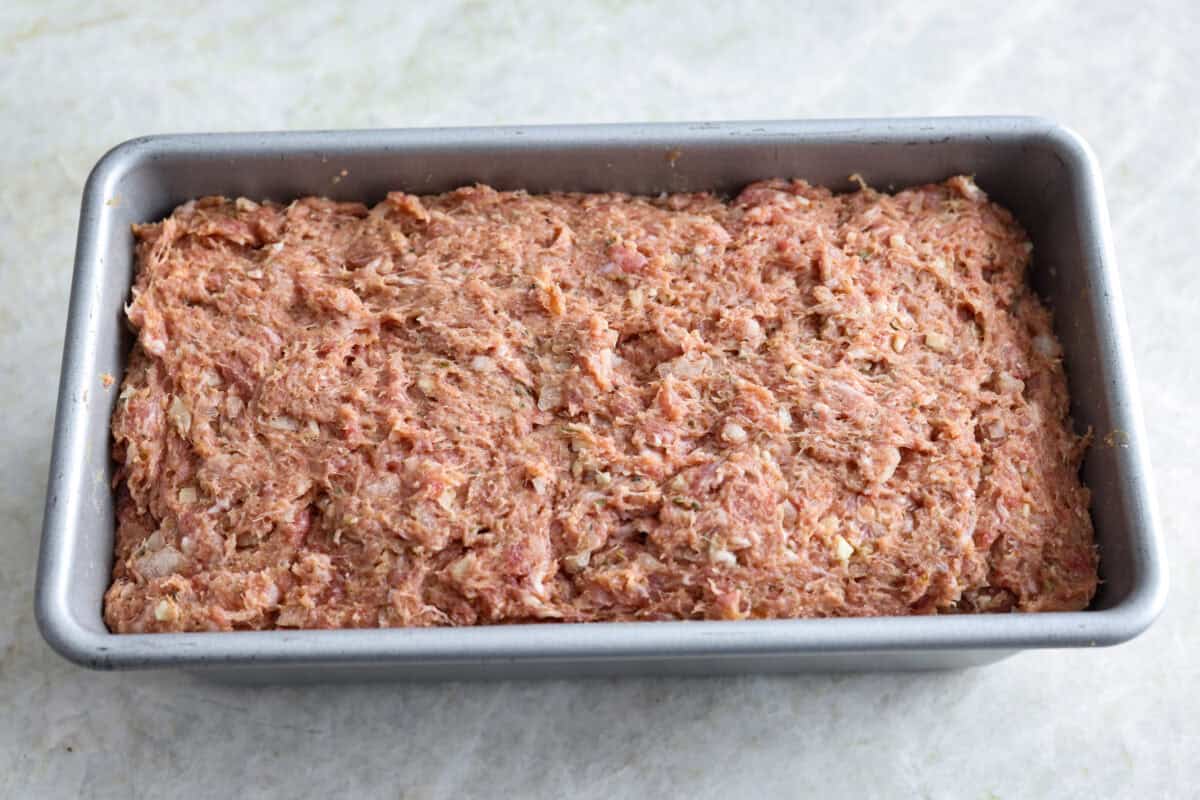 My easy-to-make gyro meat is perfectly seasoned and tender every time! Just like your favorite Mediterranean restaurant. Perfect for pitas, bowls, or platters with all your favorite toppings. Mixed meat and seasonings in a loaf pan.