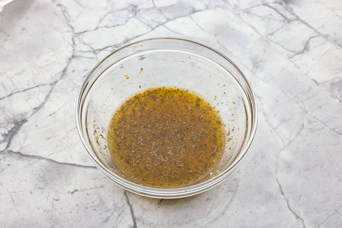My easy Cuban sandwich is stacked with tender pork, melty Swiss, tangy pickles (my favorite), and zesty mustard! Then it's toasted in butter until perfectly crisp and golden. Overhead shot of pork marinade ingredients mixed together in a bowl.