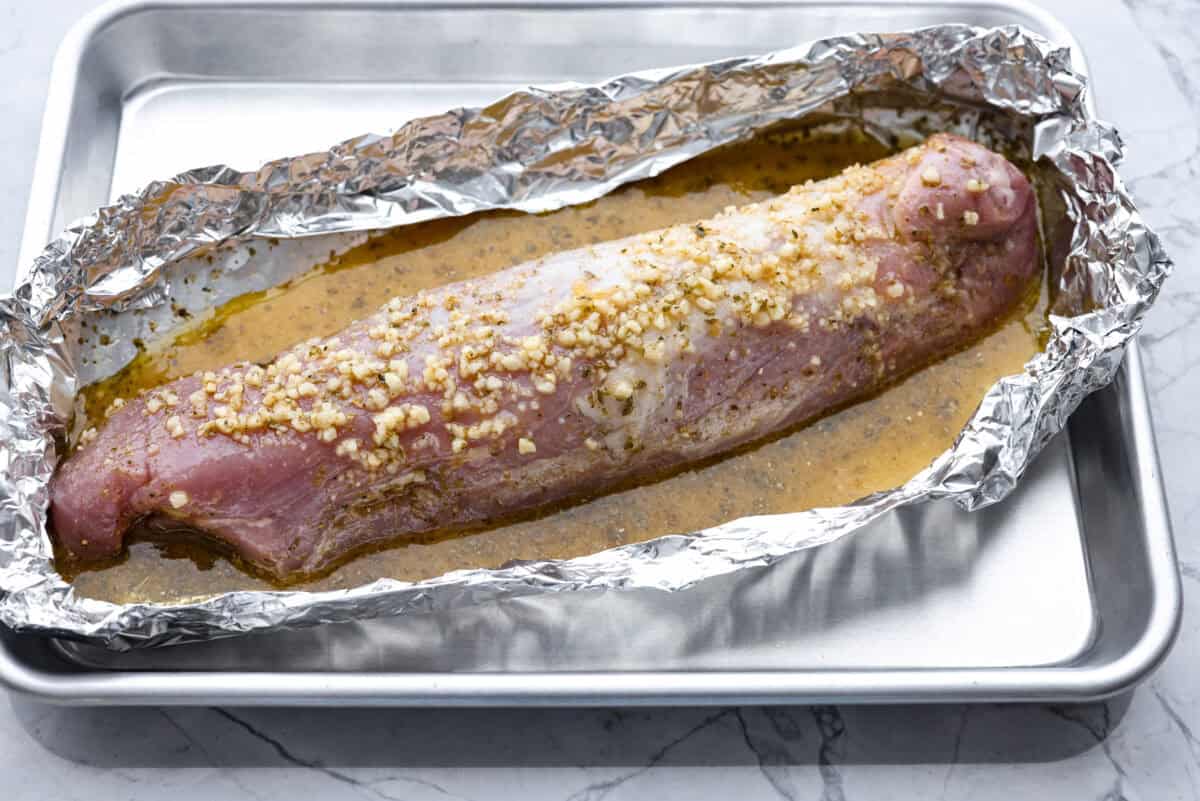 My easy Cuban sandwich is stacked with tender pork, melty Swiss, tangy pickles (my favorite), and zesty mustard! Then it's toasted in butter until perfectly crisp and golden. Pork tenderloin covered in the marinade.