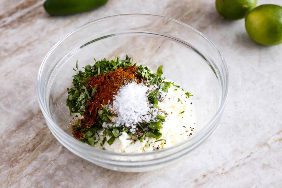 Guys, Iโm obsessed with elote, so obviously I had to turn all that smoky, creamy, cheesy, limey magic into a pasta salad big enough to feed a crowd. This oneโs guaranteed to disappear fast! Dressing ingredients all added to a bowl.