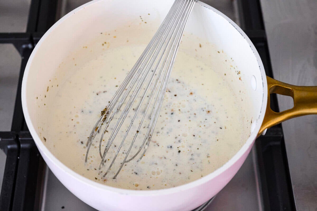 When I see Chicken Alfredo on a menu, I breathe a sigh of relief because I know my kids will actually eat it. I made this Chicken Alfredo Bake thatโs creamy, comforting, and ready in under 40 minutes. Sauce ingredients in a saucepan.