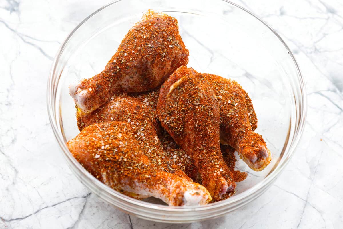My kids always fight over who gets the chicken legs. With this Air Fryer Chicken Legs recipe, I can whip up a few batches and keep everyone happy! The bold flavor and crispy air-fried skin are totally unbeatable. Chicken legs coating in olive oil and seasoning mix.