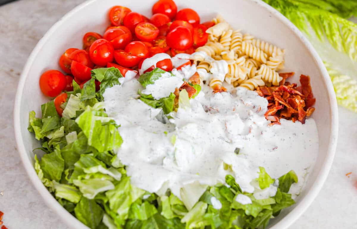 The best sandwich ever? Hands down, a BLT. Add in my obsession with pasta salads and, chefโs kiss! This BLT Pasta Salad has the crispy bacon, juicy tomatoes, and crunchy lettuce we all love! Ranch dressing poured over the pasta, bacon, tomatoes, and lettuce.