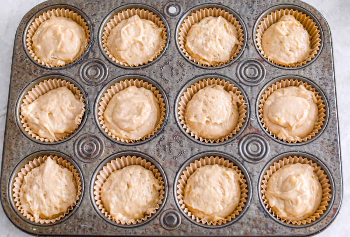 When my bananas start to turn brown and the kids need something quick, these banana muffins always save the day. They’re soft, sweet, and come together fast. Muffin tin with muffin liners and a dollop of muffin batter in each.