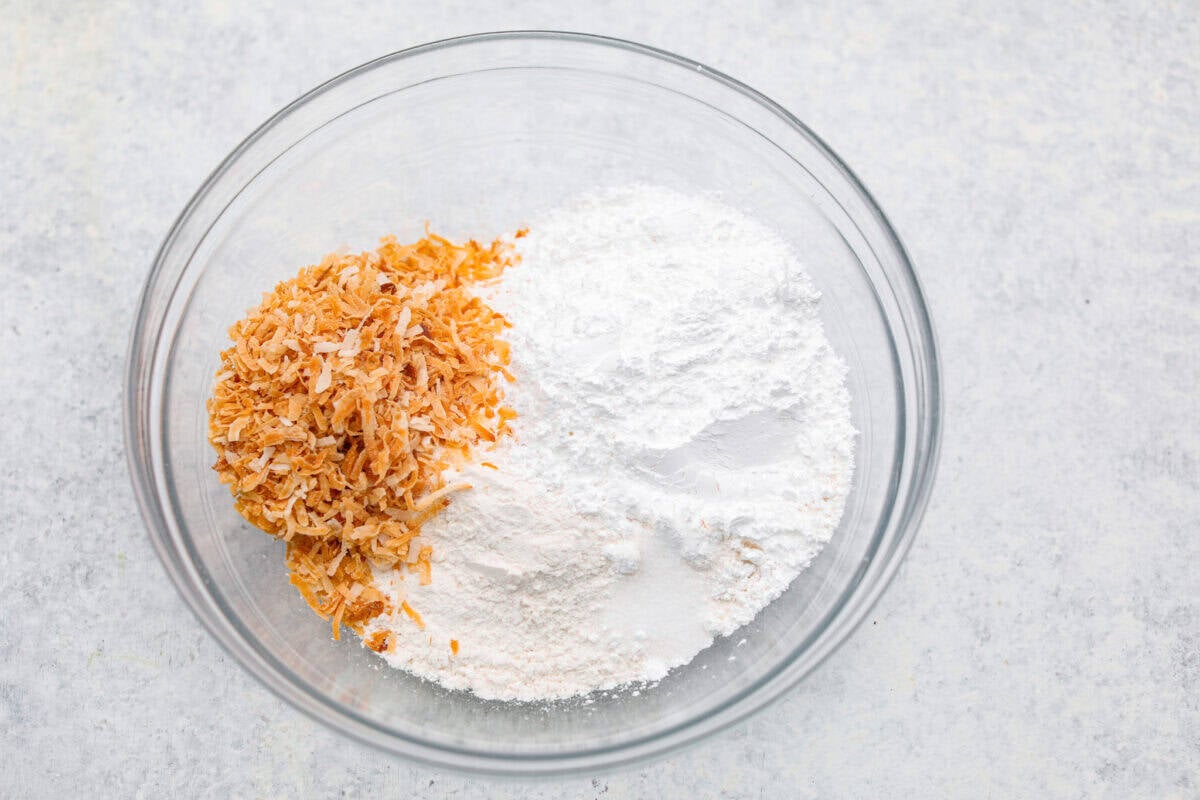 My Dad LOVES coconut cream pie! When I don't have it in me to make a pie, I make this easy Coconut Lush dessert! Itโs rich, dreamy, and always the first dessert to disappear at family gatherings. Crust ingredients added to a bowl.
