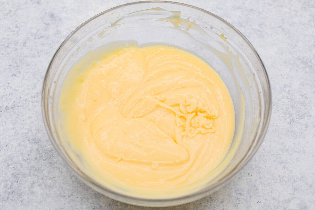 My Dad LOVES coconut cream pie! When I don't have it in me to make a pie, I make this easy Coconut Lush dessert! Itโs rich, dreamy, and always the first dessert to disappear at family gatherings. Bowl of coconut pudding.