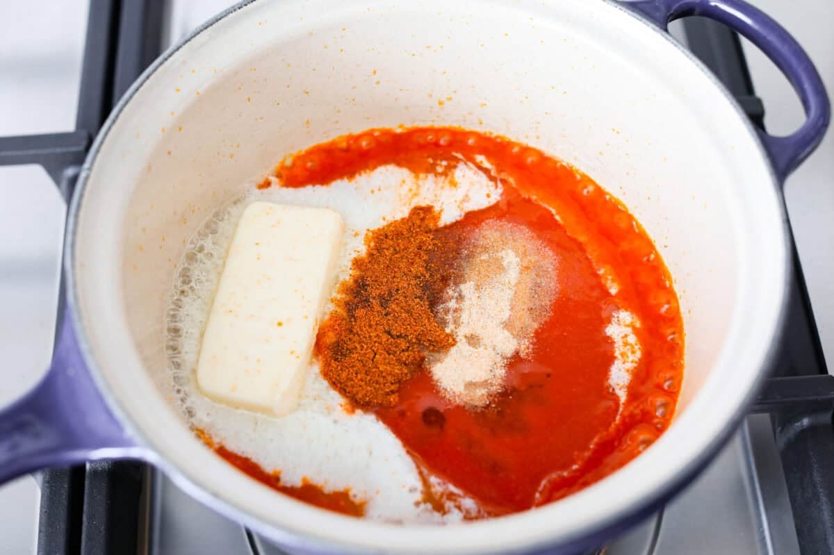 My homemade buffalo sauce is bold, tangy, and perfectly spicy! It's ready in minutes with just a few simple ingredients. Skip the store-bought stuff and make your wings, wraps, and dips next-level delicious! Sauce ingredients combined in a pot.