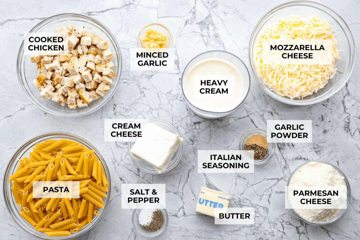When I see Chicken Alfredo on a menu, I breathe a sigh of relief because I know my kids will actually eat it. I made this Chicken Alfredo Bake thatโs creamy, comforting, and ready in under 40 minutes. Overhead shot of labeled ingredients.