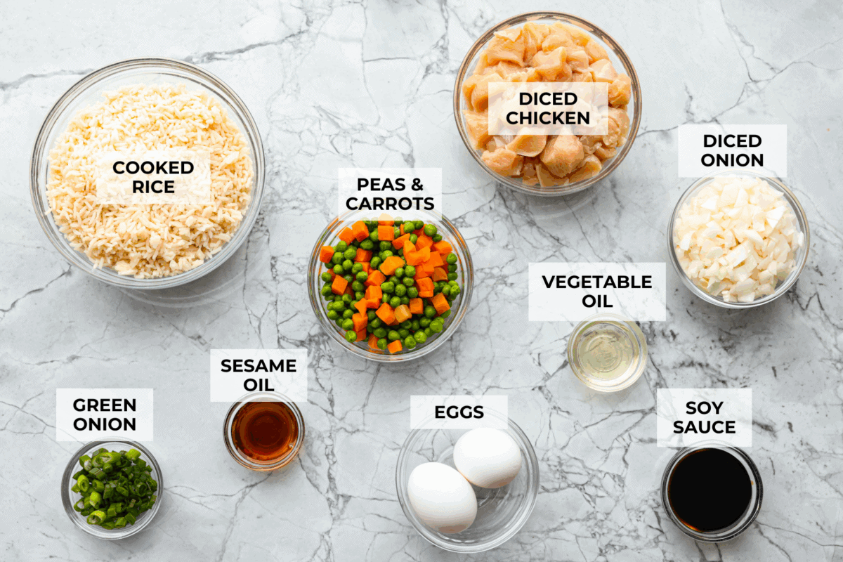 My go-to when I donโt feel like cooking? This easy chicken fried rice. I grab leftover rice and chicken, toss it all in a pan, and boom, dinner is ready in minutes. The best part? My kids devour it! Overhead shot of labeled ingredients.