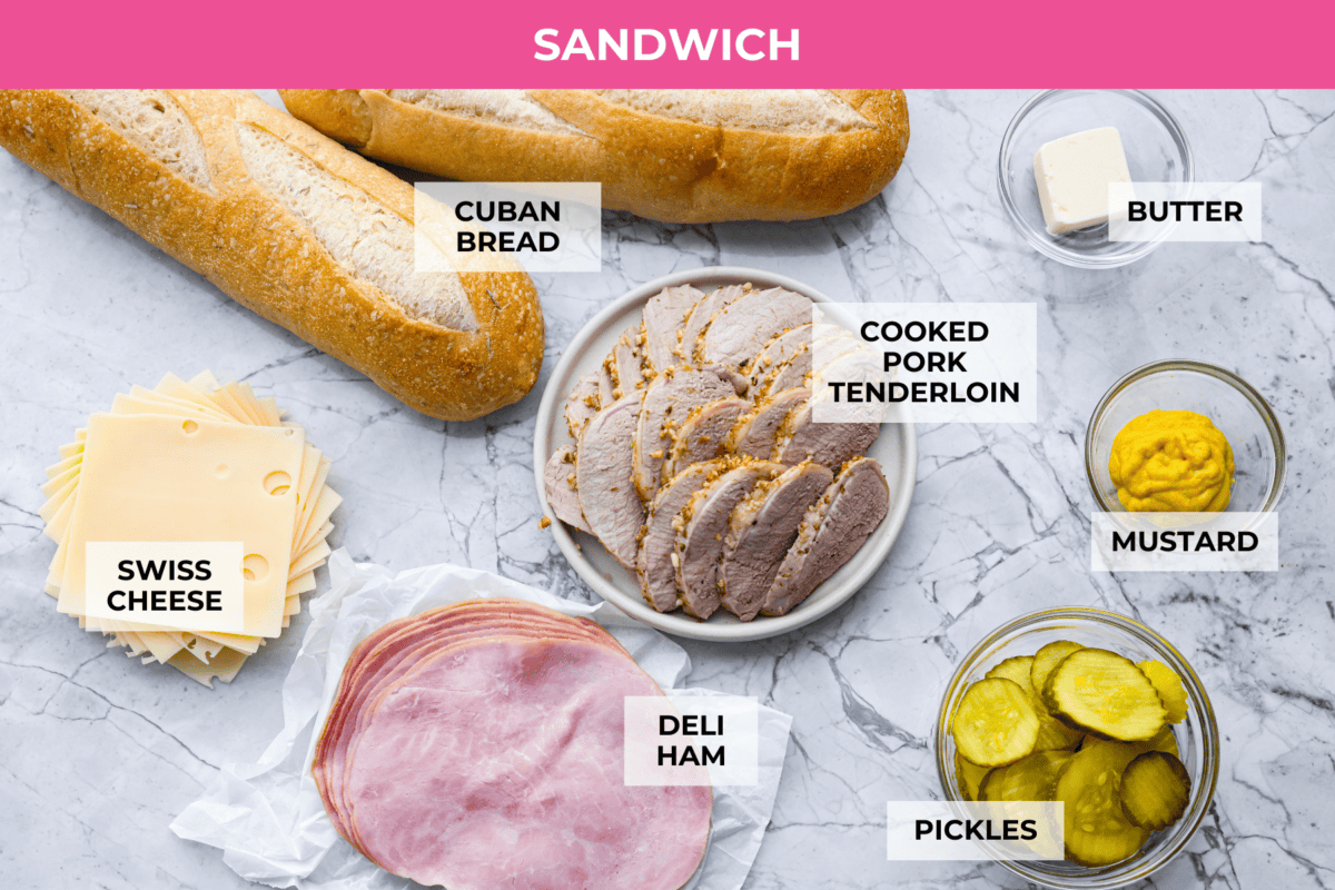 My easy Cuban sandwich is stacked with tender pork, melty Swiss, tangy pickles (my favorite), and zesty mustard! Then it's toasted in butter until perfectly crisp and golden. Overhead shot of labeled sandwich ingredients.