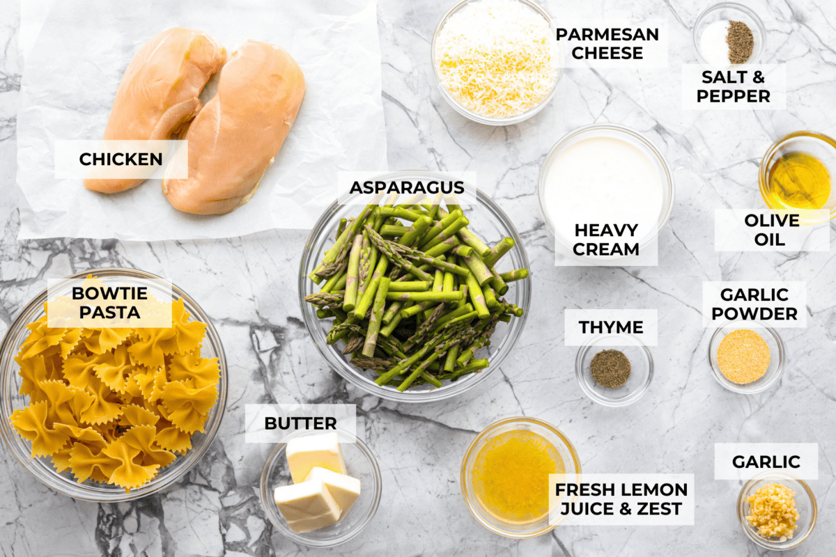 My Lemon Garlic Chicken Asparagus Pasta looks like something youโd order at a fancy bistro, but it literally takes 30 minutes! Itโs zesty, garlicky, and seriously so good! Overhead shot of labeled ingredients.