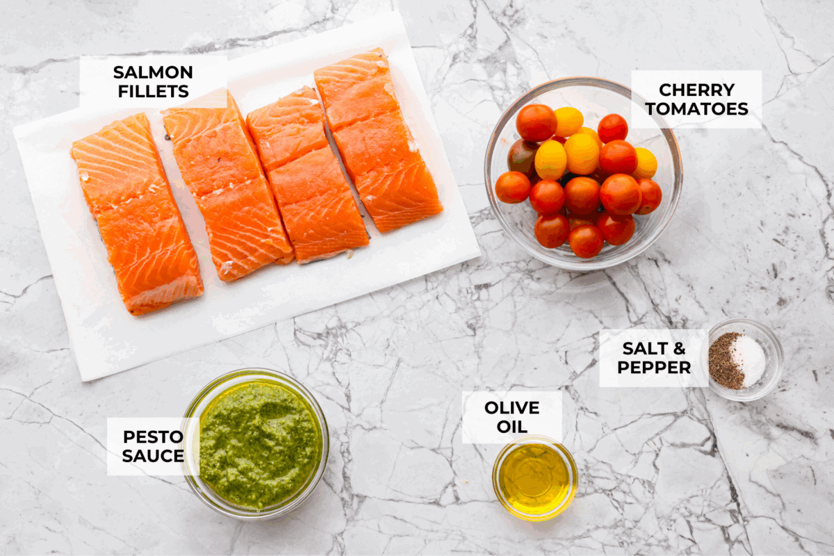 Pesto Salmon is everything. Itโs one of the easiest, lightest, most flavor-packed dinners Iโve ever made! It uses just 6 ingredients, takes 30 minutes, and it looks like you totally have your life together (even if you donโt;). Overhead shot of labeled ingredients.