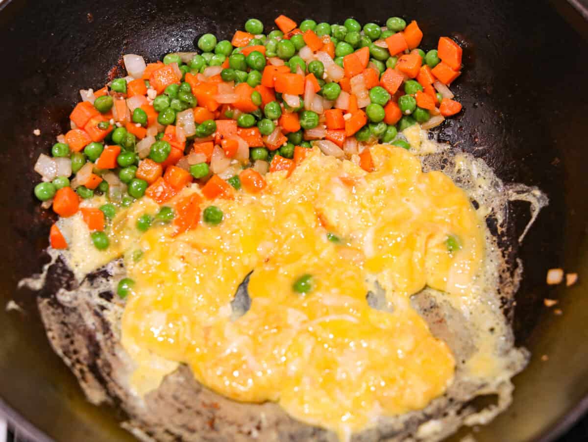 You guys know how I feel about fried rice, itโs my go-to for leftover rice and whatever meatโs in the fridge. Pork Fried Rice is savory and satisfying. With tender pork, fluffy eggs, and veggies all in one pan, itโs the ultimate weeknight win. Eggs being scrambled next to the veggies.