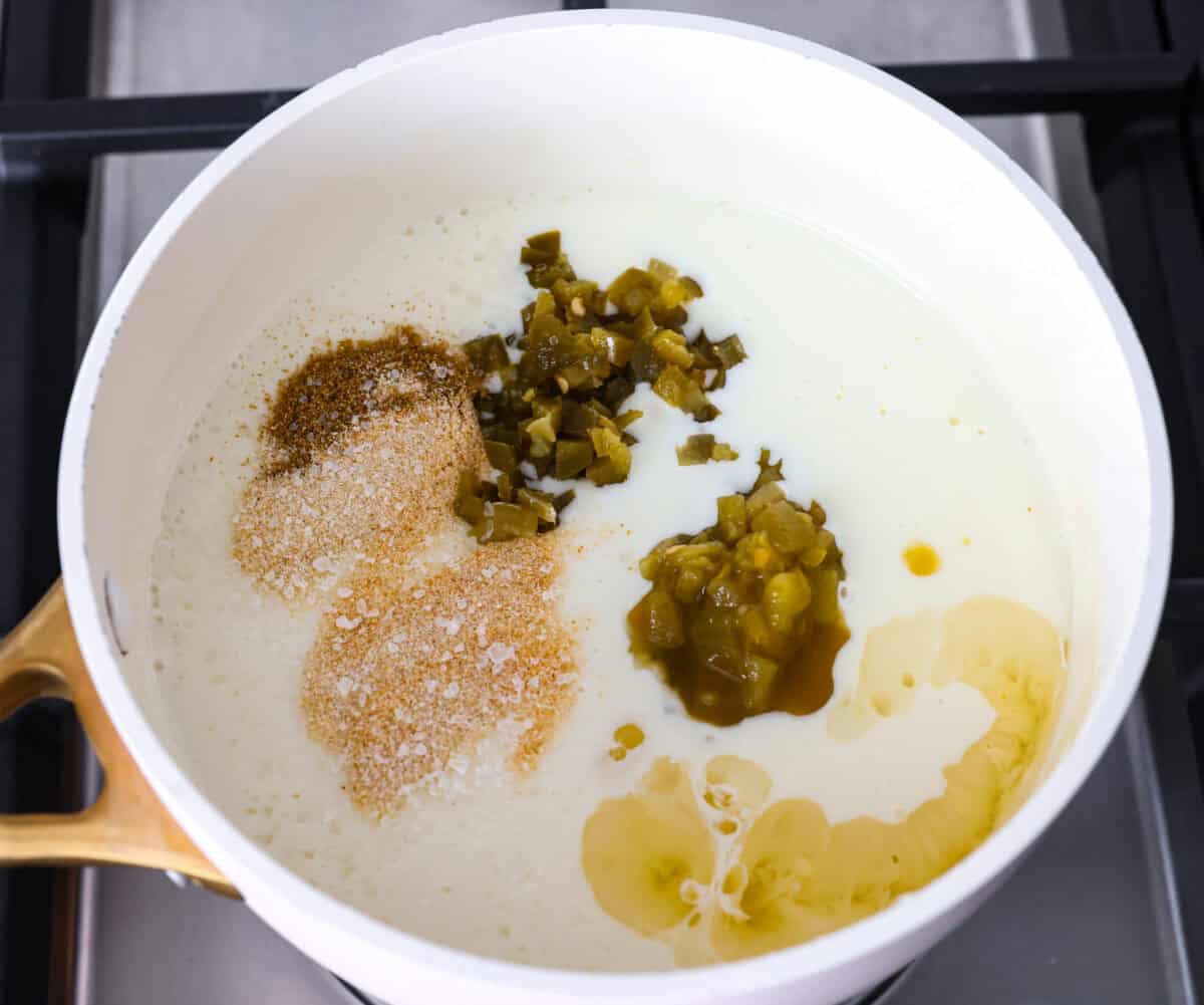 My Queso Blanco is creamy, dreamy, and seriously so addictive. The secret? White American cheese! It melts like a dream, gives you that ultra-smooth texture! Chilies, jalapeรฑos, and seasonings added to the milk and cheese mixture.
