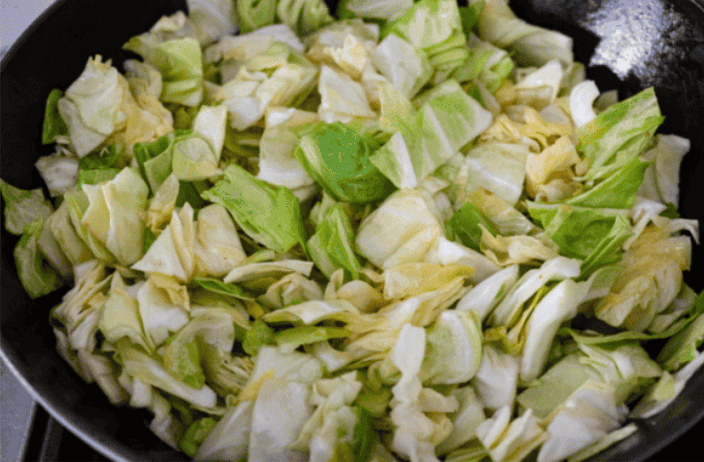 You love my cabbage rolls, and I know you guys love a casserole. So obviously, this cabbage roll casserole is the perfect match. All the delicious flavor with less work! Cabbage precooking in a pan.