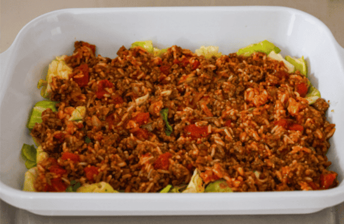 You love my cabbage rolls, and I know you guys love a casserole. So obviously, this cabbage roll casserole is the perfect match. All the delicious flavor with less work! Meat mixture layered on top of the cabbage.