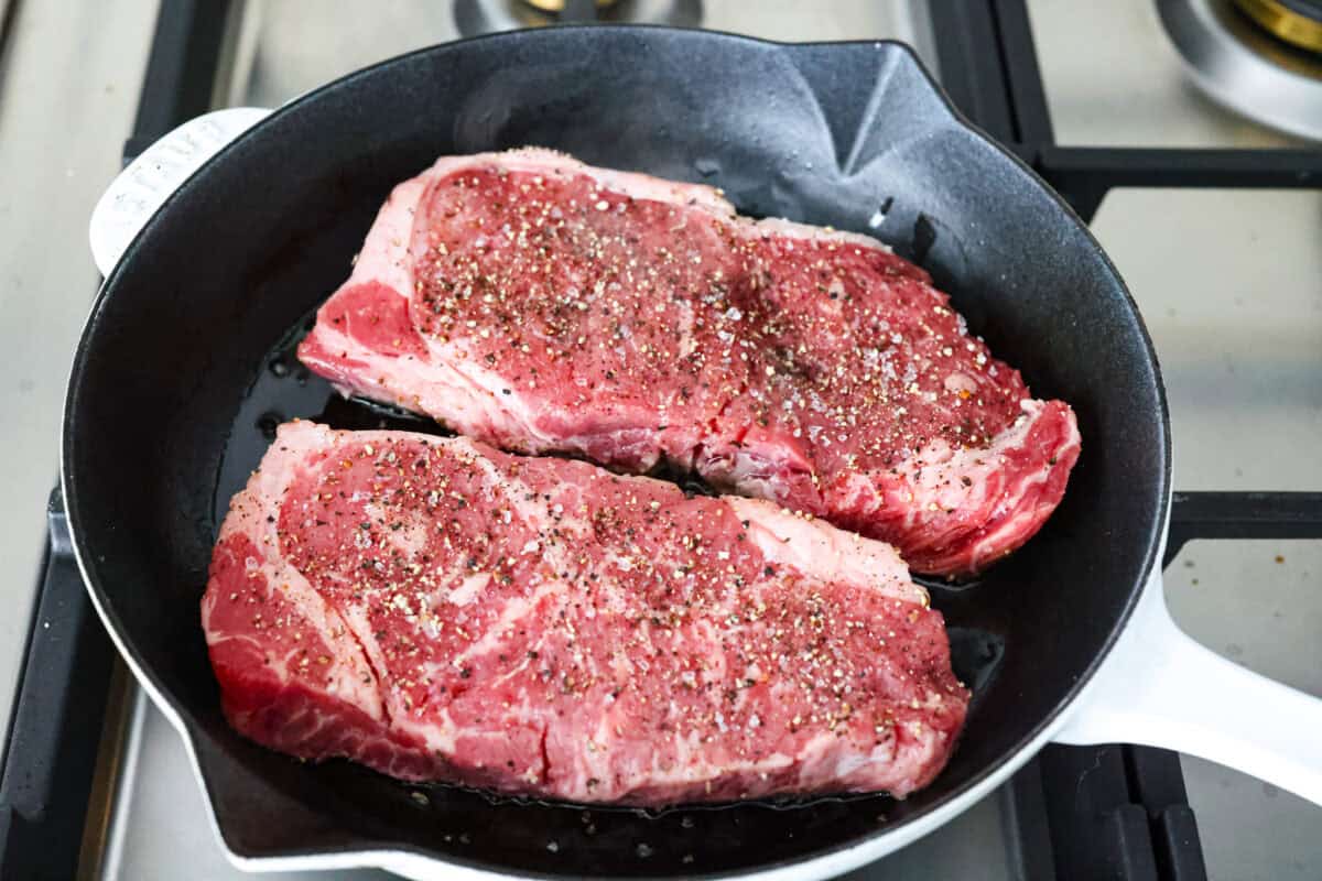 If there’s one dinner that never goes out of style, it’s steak and potatoes, especially when they’re seared to perfection in a hot skillet with garlic butter and fresh herbs. This one-pan meal is full of rich, savory flavor and comes together fast. Seasoned steak searing in a skillet.