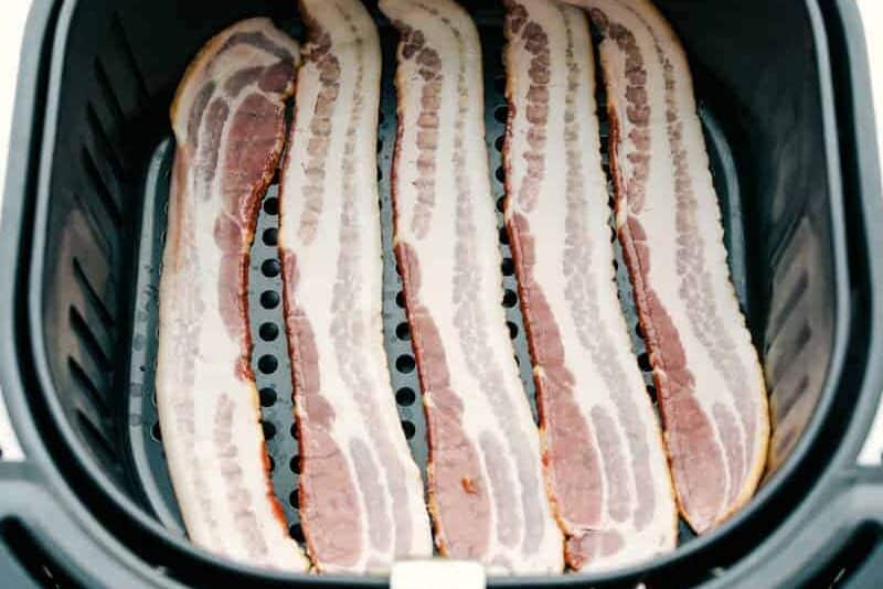 You know how much I love my air fryer, and this might be my favorite hack yet: Air Fryer Bacon! It’s ready in 10 minutes, no flipping, no mess, and turns out perfectly crispy every single time Overhead shot of raw bacon in the air fryer basket.