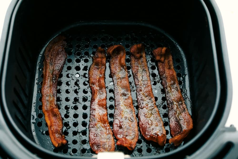 You know how much I love my air fryer, and this might be my favorite hack yet: Air Fryer Bacon! It’s ready in 10 minutes, no flipping, no mess, and turns out perfectly crispy every single time Overhead shot of cooked bacon at the bottom of the basket.