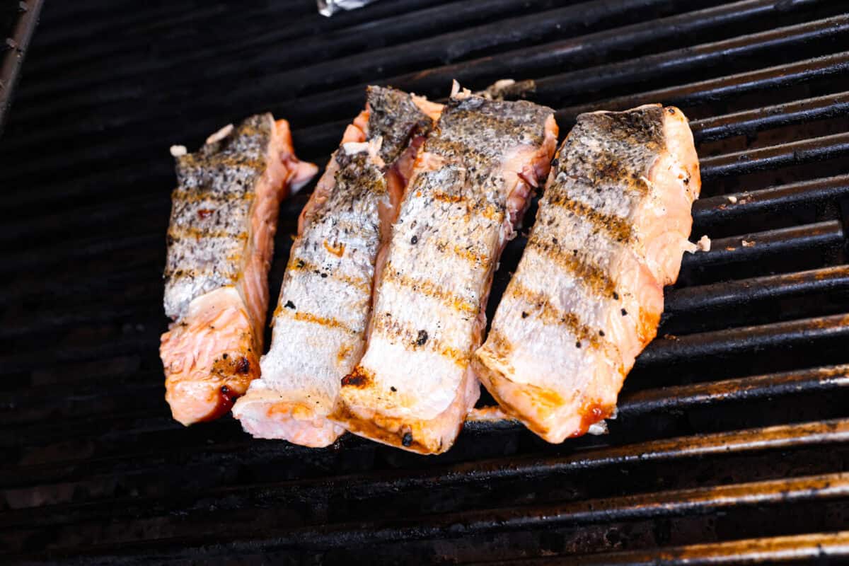 You guys know I'm obsessed with salmon! This BBQ salmon is perfectly smoky, tender, and coated in my mouthwatering homemade barbecue sauce. Salmon Filets flipped over to get grill marks.