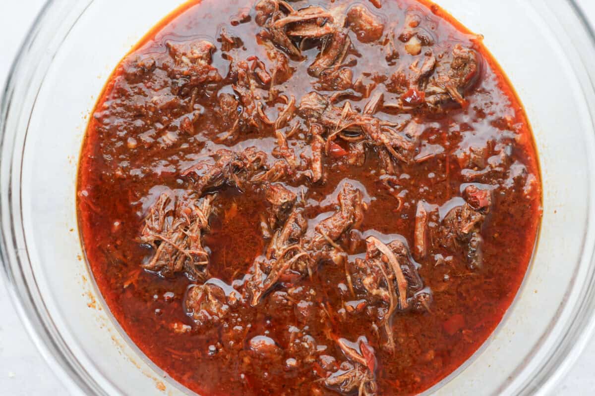 My Birria Ramen is next-level delicious! Tender shredded chuck roast, rich consommé, and slurp-worthy noodles all in one bowl. Shredded beef in the Birria ramen broth in a bowl.