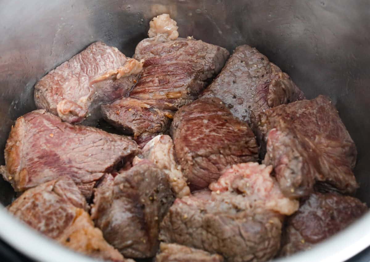 My Birria Ramen is next-level delicious! Tender shredded chuck roast, rich consommé, and slurp-worthy noodles all in one bowl. Seared beef in the bottom of a crockpot.