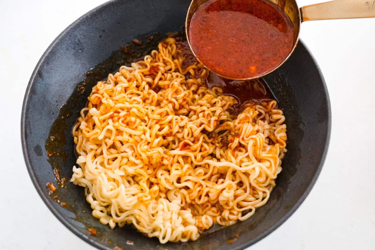 My Birria Ramen is next-level delicious! Tender shredded chuck roast, rich consommé, and slurp-worthy noodles all in one bowl. Someone pouring broth over noodles in a bowl.