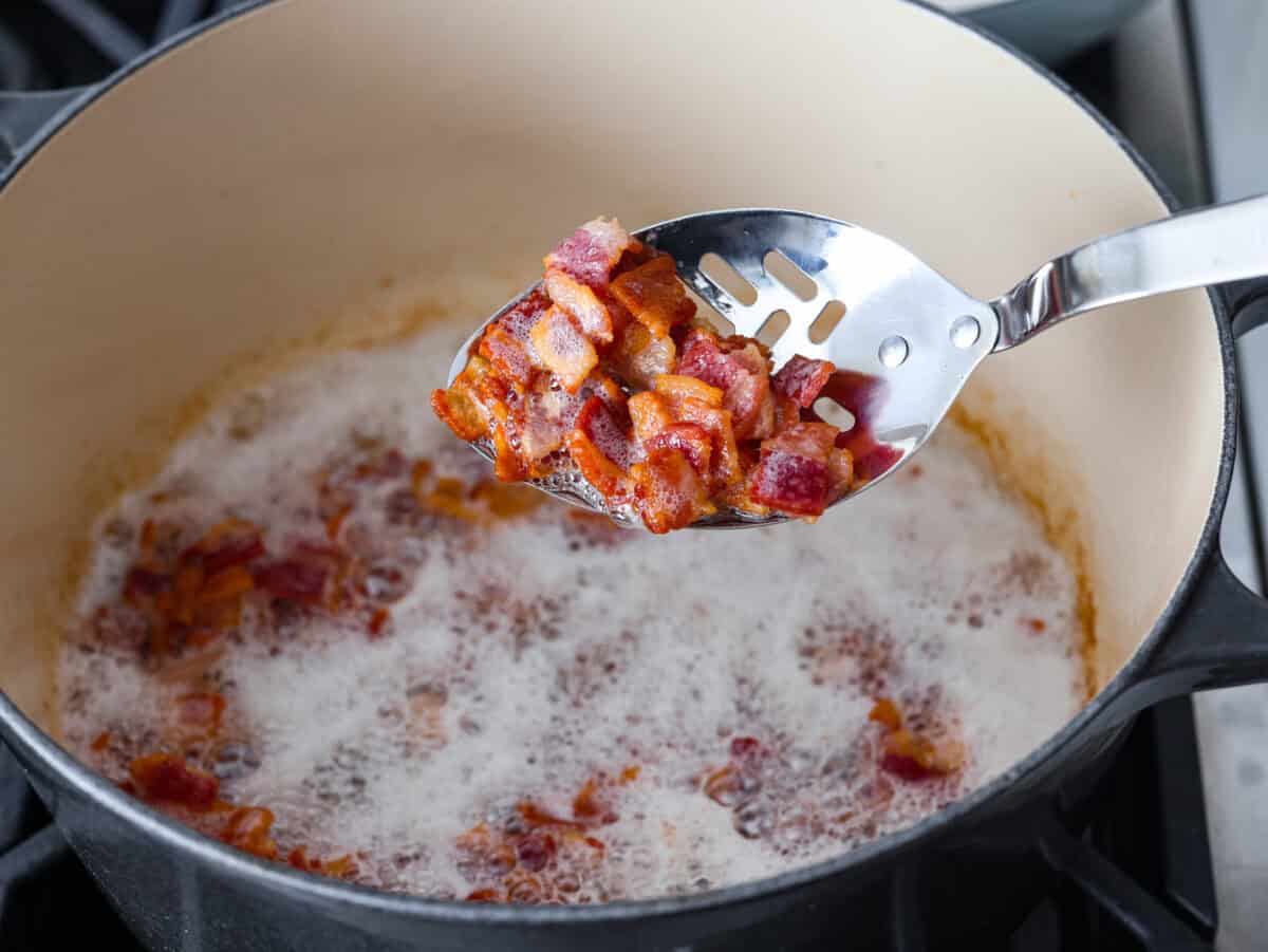 Every time I bring these cowboy beans to a summer BBQ, people start begging for the recipe, and honestly, I donโt blame them. Theyโre hearty, a little smoky, a little sweet, and always the first thing to disappear. Bacon cooking in the bottom of a dutch oven.