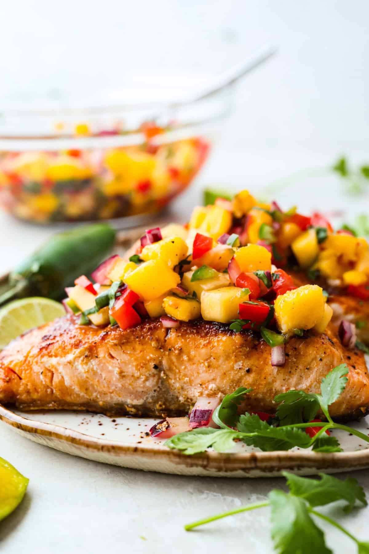 Iโm obsessed with salmon, and this Mango Salsa Salmon might just be my new favorite! Itโs super flavorful, fast to cook, and somehow my kids donโt fight me on it. That bright, juicy salsa on top? Freaking amazing. I could eat it every night! Side shot of plated mango salsa salmon.