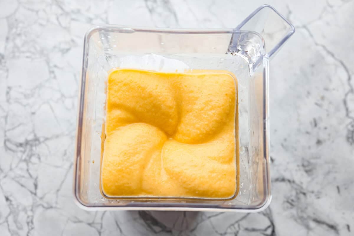Peach smoothie perfection starts here! It’s fresh, juicy, and extra creamy thanks to Greek yogurt. And a protein boost to power you through your busy morning. Ingredients blending in a blender.