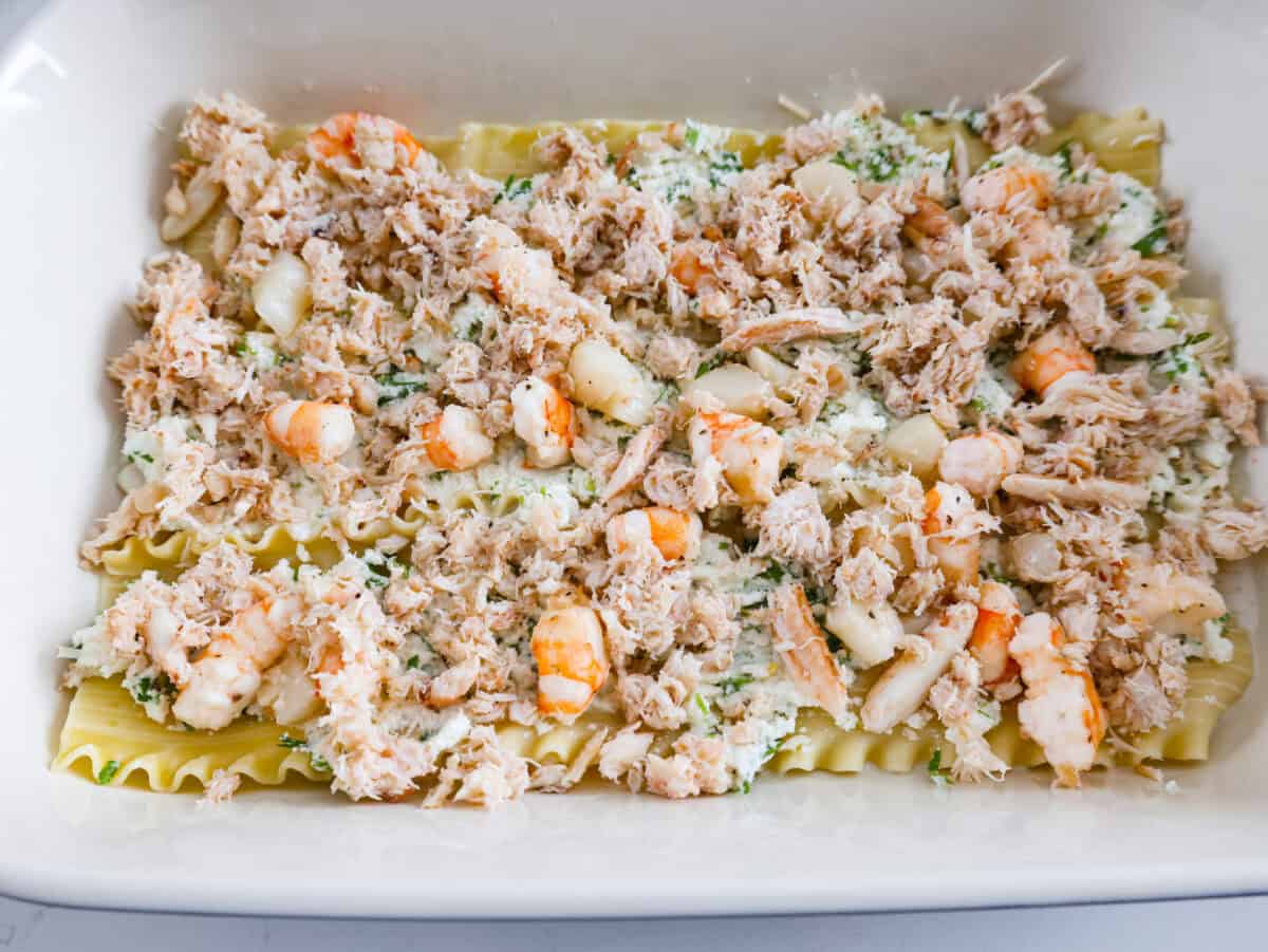 If youโre a seafood lover, you'll be obsessed with this Seafood Lasagna. Iโm talking crab, scallops, and shrimp in creamy, cheesy layers, baked to bubbly perfection. Itโs my go-to dinner when Iโm cooking for seafood fans! Seafood mixture added on top of the ricotta mixture.