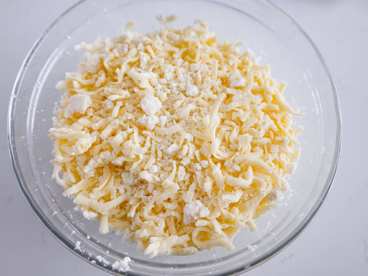 If youโre a seafood lover, you'll be obsessed with this Seafood Lasagna. Iโm talking crab, scallops, and shrimp in creamy, cheesy layers, baked to bubbly perfection. Itโs my go-to dinner when Iโm cooking for seafood fans! Different shredded cheeses mixed together in a bowl.